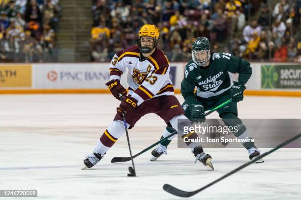 Minnesota Gophers defenseman Ryan Johnson skates with the puck during the college hockey game between the Michigan State Spartans and the Minnesota...