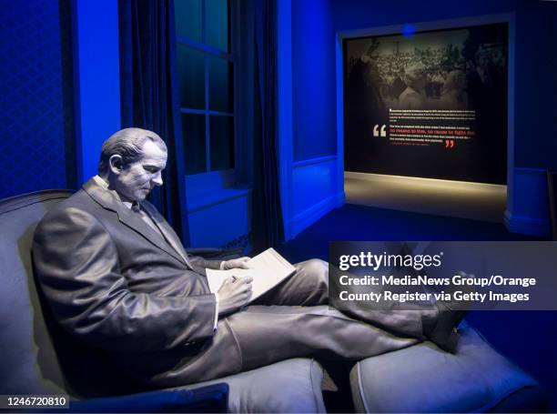 Richard Nixon is in the spotlight. The 37th president writes on a yellow note pad in the Lincoln room. The new Richard Nixon Presidential Library &...