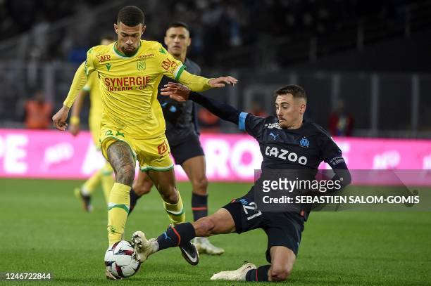 Nantes' Brazilian defender Joao Victor fights for the ball with Marseille's French midfielder Valentin Rongier during the French L1 football match...