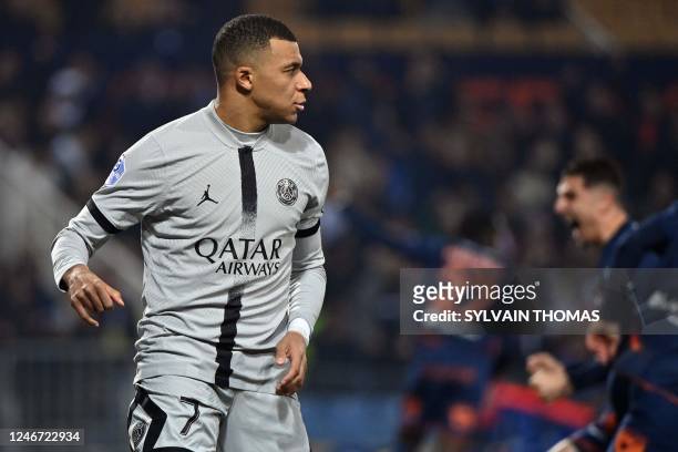 Paris Saint-Germain's French forward Kylian Mbappe reacts after missing a penalty during the French L1 football match between Montpellier Herault SC...