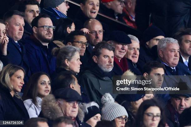 Artist Michael Brown sits in the stands alongside Former Manchester United manager Sir Alex Ferguson and former manager Steve Bruce during the...