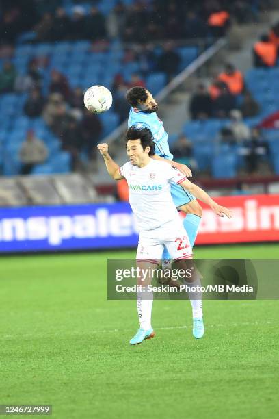 Manolis Siopis of Trabzonspor and Shoya Nakajima of Antalyaspor battle for the ball during the Super Lig match between Trabzonspor and Antalyaspor at...