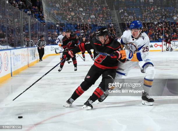 Jesperi Kotkaniemi of the Carolina Hurricanes controls the puck against Owen Power of the Buffalo Sabres during an NHL game on February 1, 2023 at...