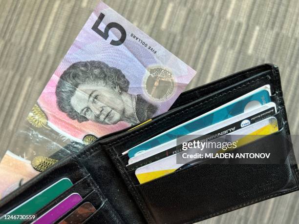 This photo illustration taken in Hong Kong on February 2, 2023 shows the Australian $5 banknote. - Australia's central bank announced on February 2,...