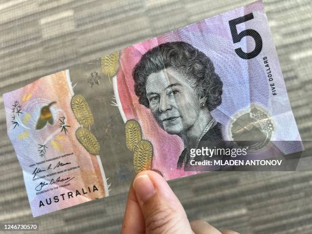 This photo illustration taken in Hong Kong on February 2, 2023 shows the Australian $5 banknote. - Australia's central bank announced on February 2,...