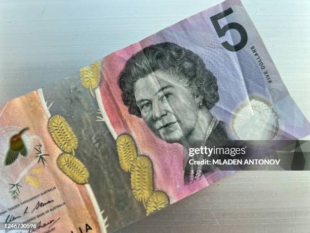 This photo illustration taken in Hong Kong on February 2, 2023 shows the Australian $5 banknote. - Australia's central bank announced on February 2,...