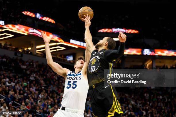 Luka Garza of the Minnesota Timberwolves and Stephen Curry of the Golden State Warriors compete for the rebound in the first quarter of the game at...