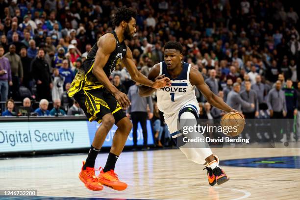 Anthony Edwards of the Minnesota Timberwolves drives to the basket while Andrew Wiggins of the Golden State Warriors defends during overtime at...