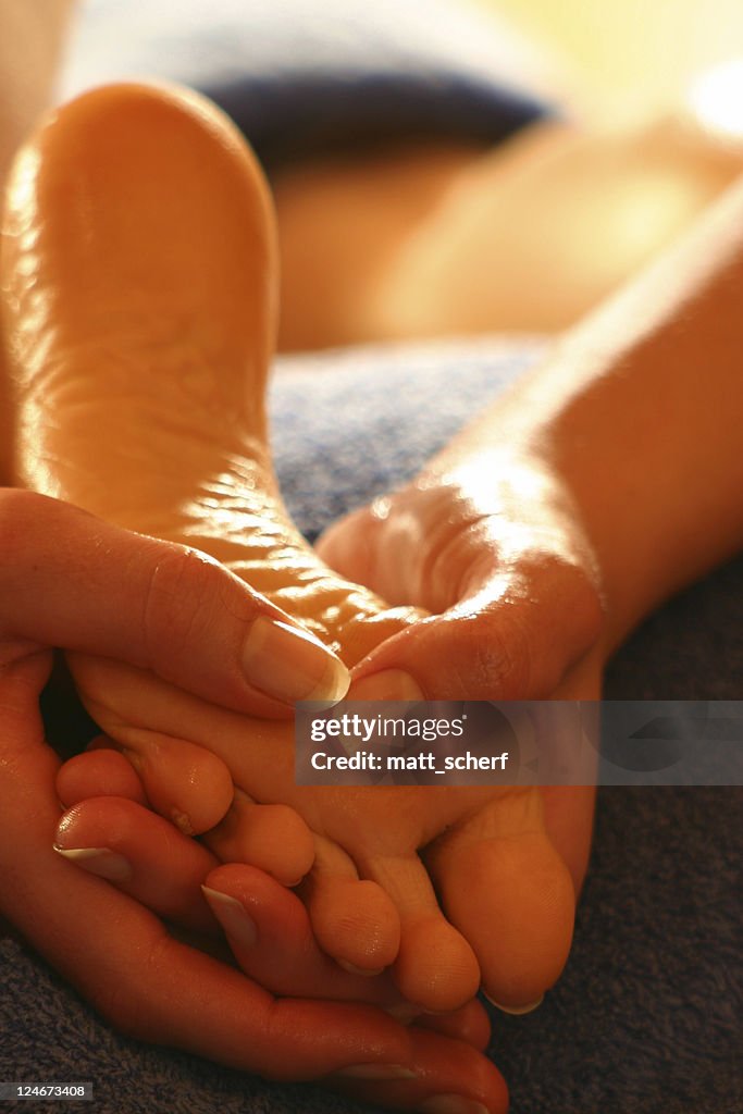 Close-up of hands massaging a foot