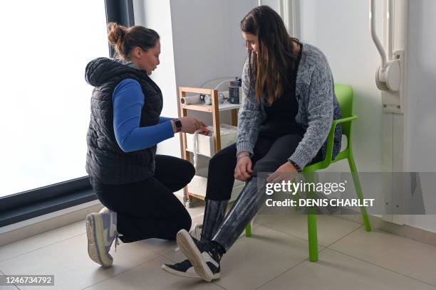 Estelle Lehouck, amputated from both legs to the knees, meets with her orthoprosthetist Marion Fourmaux at her office to adjust her glittery...