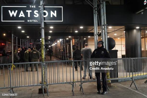 New York Police Department polices and Department of Sanitation workers clear asylum seekers from the sidewalk in front of Watson Hotel in Hellâs...