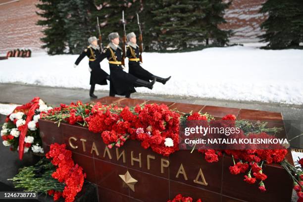 Russian honour guards march behind a memorial stone reading Stalingrad with flowers left on it to mark the 80th anniversary of the Soviet victory at...