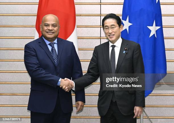 Japanese Prime Minister Fumio Kishida shakes hands with H.E. David W. Panuelo, president of the Federated States of Micronesia, before their talks at...