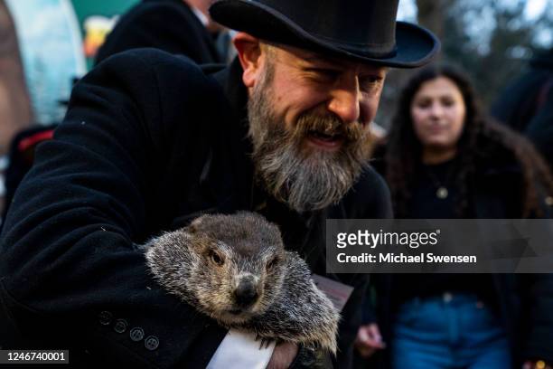 Groundhog handler AJ Derume holds Punxsutawney Phil, who saw his shadow, predicting a late spring during the 137th annual Groundhog Day festivities...