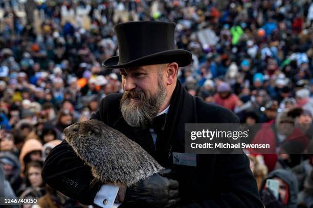 Groundhog handler AJ Derume holds Punxsutawney Phil, who saw his shadow, predicting a late spring during the 137th annual Groundhog Day festivities...