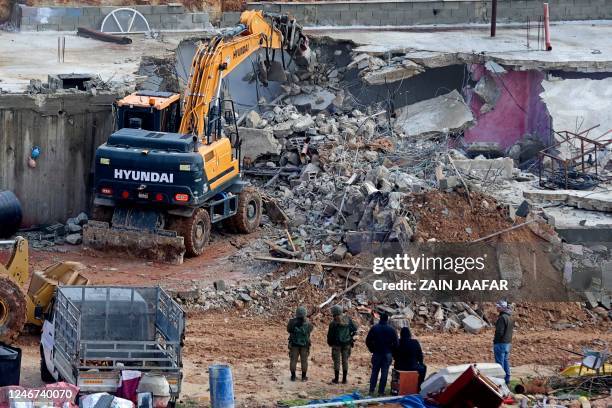 Israeli bulldozers demolish a Palestinian owned house, built without a permit from the Israeli authorities in the area C which lies under their...