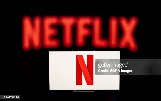 In this photo illustration, the Netflix logo is seen displayed on a mobile phone screen.