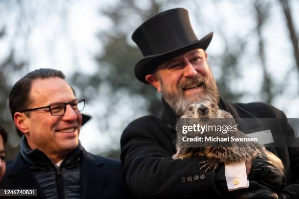 Pennsylvania Governor Josh Shapiro poses for a portrait with Groundhog handler AJ Dereume and Punxsutawney Phil, who saw his shadow, predicting a...