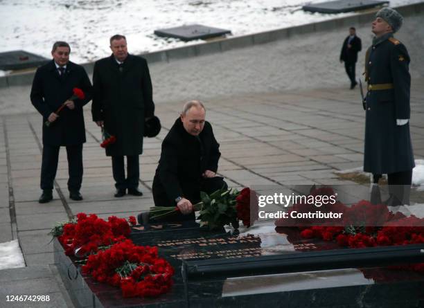 Russian President Vladimir Putin puts flowers while visiting the Mamayev Kurgan, a memorial complex commemorating the heroes of the Battle of...
