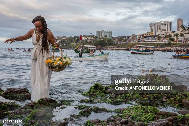 Worshippers take part in the traditional ceremony of Iemanja, the Goddess of the Sea of the syncretic Afro-Brazilian religion Umbanda at the Rio...