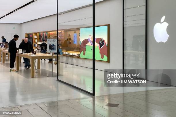 People shop at the Apple Store in Annapolis, Maryland, on February 2, 2023. - Tech giants Google, Apple and Amazon will report their latest results...
