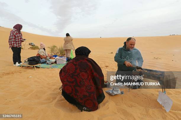 Man grills for his family in al-Ramla area near the Libyan town of Ghadames, a desert oasis some 650 kilometres southwest of the capital Tripoli, on...