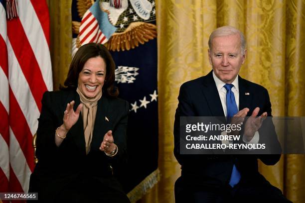 Vice President Kamala Harris and US President Joe Biden applaud during an event marking the 30th Anniversary of the Family and Medical Leave Act, in...