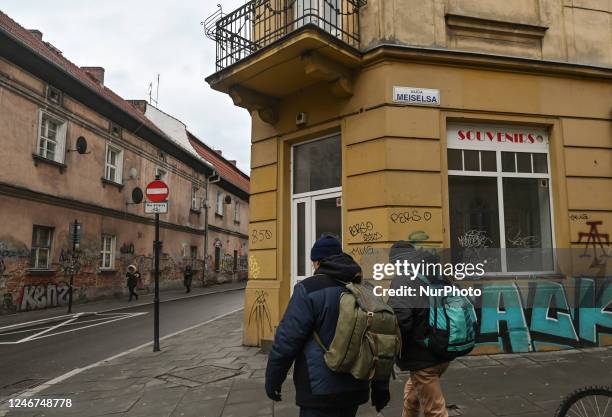 Two men walk past a closed business premises in the center of Krakow, Poland on February 02, 2023. In 2022, Poland's GDP increased by 4.9 percent....