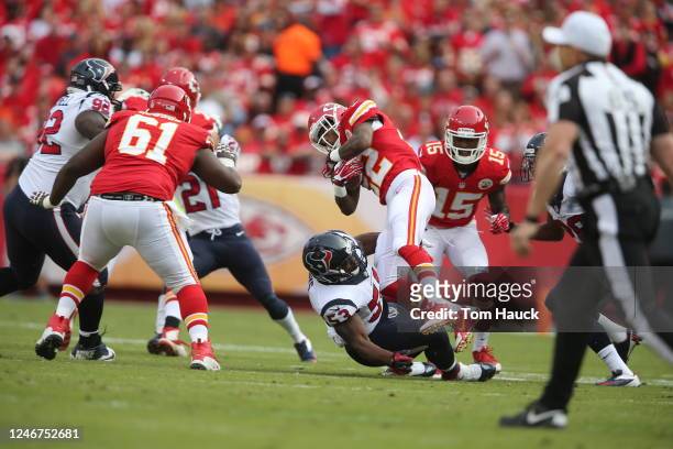 Kansas City Chiefs wide receiver Dexter McCluster gets tripped up by Houston Texans inside linebacker Joe Mays during an NFL football game between...