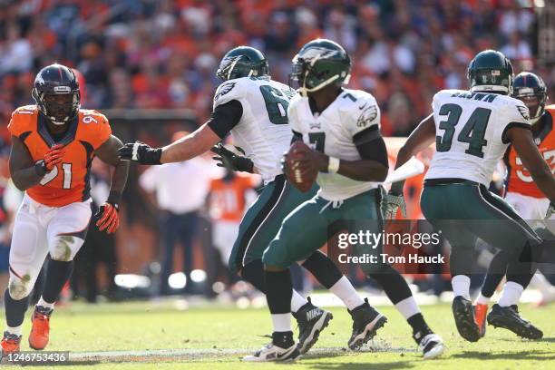 Denver Broncos defensive end Robert Ayers runs after Philadelphia Eagles quarterback Michael Vick during the Philadelphia Eagles against the Denver...