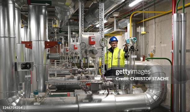 Picture taken on January 19, 2023 shows Thomas Gilg, head of the geothermal heating plant in Munich, southern Germany, checking the technology. - For...