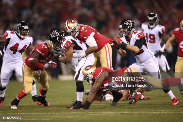 Atlanta Falcons running back Jacquizz Rodgers runs with the ball as he is gang tackled by San Francisco 49ers Anthony Dixon , Corey Lemonier...