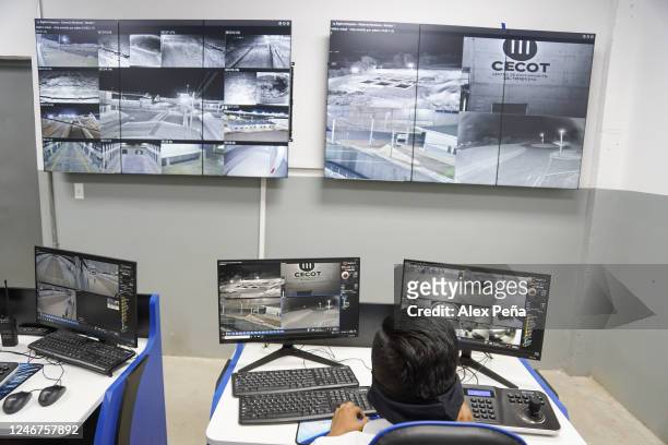 An officer supervises video monitors in the Terrorism Confinement Center on February 2, 2023 in San Vicente, El Salvador. Authorities in El Salvador...