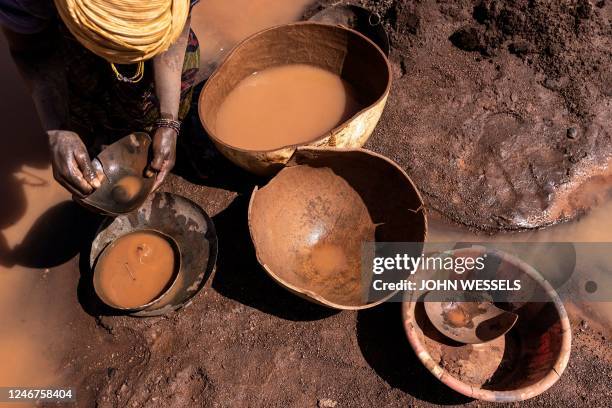 An artisanal miner pans for gold at the Karakaene gold mine on February 1, 2023. - Karakaene has one of the largest artisanal gold mining sites in...