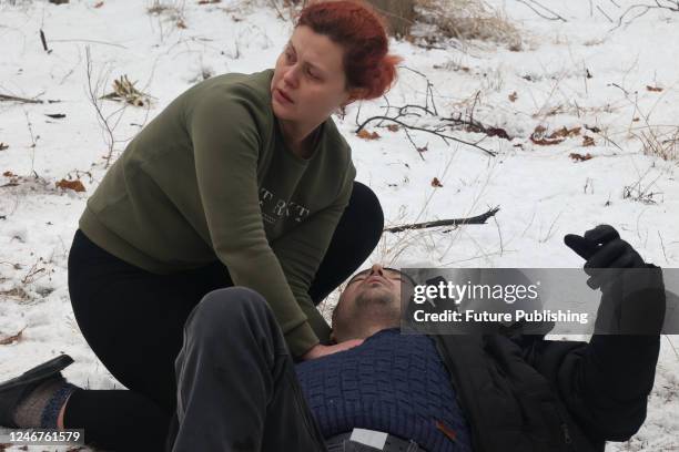 Woman gives first aid to a man injured in a rocket attack of Russian troops, Kramatorsk, Donetsk Region, eastern Ukraine.