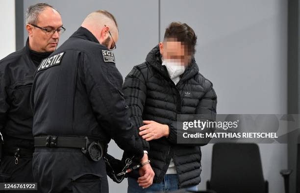 Judicial officers bring defendant Bashir R into the courtroom of the Higher Regional Court in Dresden, eastern Germany on February 3, 2023 prior to a...