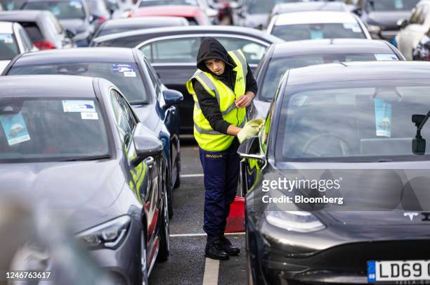 An employee cleans a used car for sale at Big Motoring World's showroom near Chatham, UK, on Friday, Feb. 3, 2023. Used car prices took off in 2020...