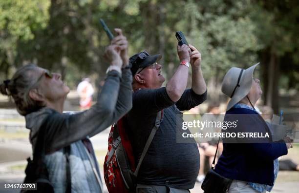 Tourists take pictures outside the Museum of Anthropology and History in Mexico City on February 1, 2023. - Mexico City is attracting a rising number...