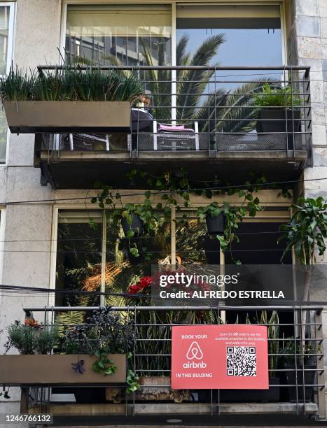 Sign displaying the logo of the online lodging service Airbnb hangs outside an apartment building at the Roma neighborhood in Mexico City on February...
