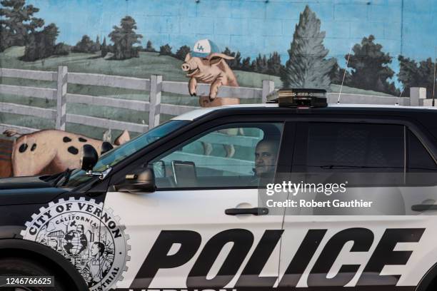 Vernon, CA, Thursday, February 2, 2023 - A city of Vernon police officer passes in front of the Farmer John meat processing plant. After years of...