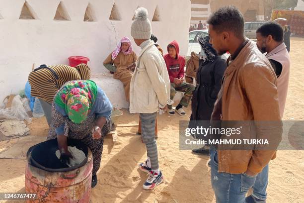 Libyan woman bakes flatbread in the Libyan town of Ghadames, a desert oasis some 650 kilometres southwest of the capital Tripoli on February 3, 2023.