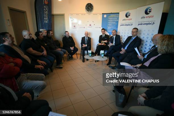 French Labour Minister Olivier Dussopt speaks with trainees learning to become bus drivers, flanked by the sub-prefect of Tarn Fabien Chollet and the...