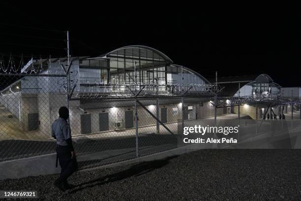 Prison security agent guards outside the maximum security prison during a visit to the Terrorism Confinement Center in San Vicente on February 2,...