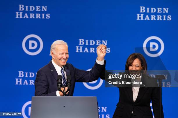 President Joe Biden, left, holds hands with US Vice President Kamala Harris during the Democratic National Committee winter meeting in Philadelphia,...