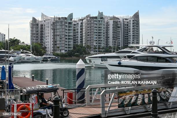 This picture taken on February 1, 2023 shows Sentosa Cove private residential housing next to yachts docked at One 15 Marina Sentosa Cove in...