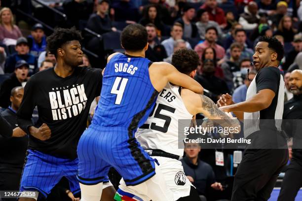 Mo Bamba of the Orlando Magic throws a punch as teammate Jalen Suggs gets into a scrum with Austin Rivers of the Minnesota Timberwolves in the third...