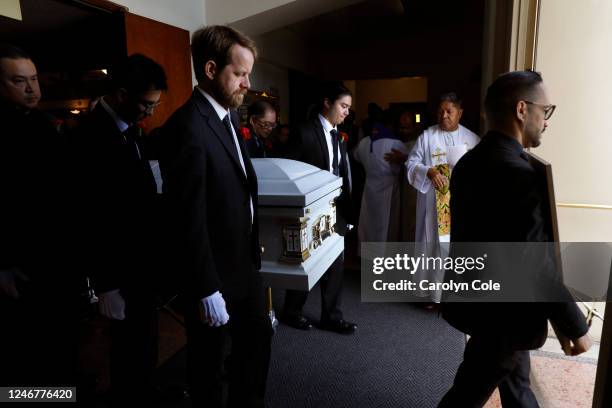 Pallbearers including Skyler Reidy, left front, carry the casket of Valentino Alvero out of the church after the funeral service at Saint Stephen...