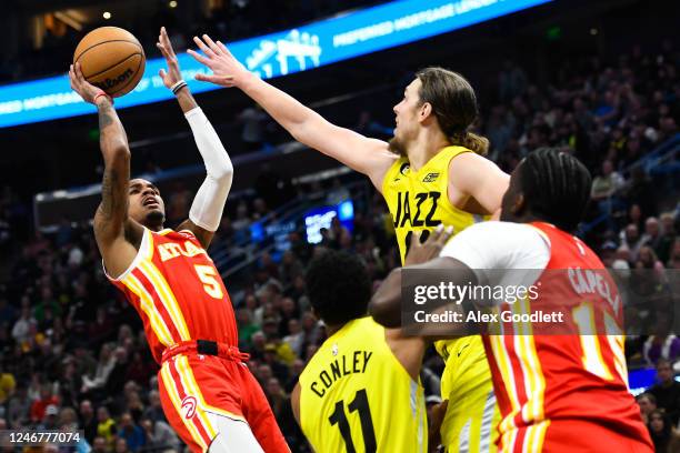 Dejounte Murray of the Atlanta Hawks shoots over Kelly Olynyk of the Utah Jazz during the second half of a game at Vivint Arena on February 03, 2023...