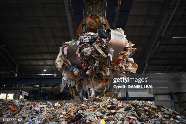 Crane grabs plastic and paper for recycling at the Cory Western Riverside facility, part of the Cory Riverside Energy, in Wandsworth, in London, on...