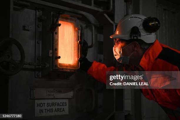 An engineer looks through a window into an incinerator grate burning household waste at 1000C, at the Cory Riverside Energy, in east London, on...